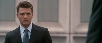 Movie still from “The Lincoln Lawyer” (2011), directed by Brad Furman – A man wearing a suit and tie standing outside; Close Up shot, Over the shoulder angle