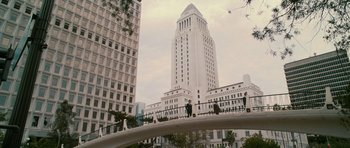 Movie still from “The Lincoln Lawyer” (2011), directed by Brad Furman – People are standing on a bridge in front of a large building; Extreme Wide shot, High angle