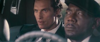 Movie still from “The Lincoln Lawyer” (2011), directed by Brad Furman – A person wearing a suit and tie; Close Up shot, Over the shoulder angle