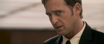 Movie still from “The Lincoln Lawyer” (2011), directed by Brad Furman – A person wearing a suit and tie; Close Up shot, Over the shoulder angle