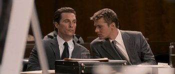Movie still from “The Lincoln Lawyer” (2011), directed by Brad Furman – A couple of men sitting next to each other in a courtroom; Close Up shot, Over the shoulder angle