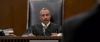 Movie still from “The Lincoln Lawyer” (2011), directed by Brad Furman – A man in a judge's robe is sitting at a podium; Close Up shot, Low angle