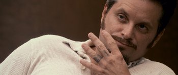 Movie still from “The Lincoln Lawyer” (2011), directed by Brad Furman – A person with tattoos on their fingers; Close Up shot, Over the shoulder angle