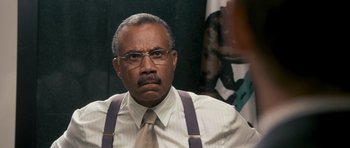 Movie still from “The Lincoln Lawyer” (2011), directed by Brad Furman – An older man wearing a tie and suspenders; Close Up shot, Over the shoulder angle