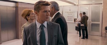 Movie still from “The Lincoln Lawyer” (2011), directed by Brad Furman – A man in a suit and tie standing next to another man in a suit and tie; Close Up shot, Over the shoulder angle