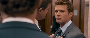 Movie still from “The Lincoln Lawyer” (2011), directed by Brad Furman – A man in a suit is looking at himself in the mirror; Close Up shot, Over the shoulder angle