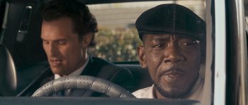 Movie still from “The Lincoln Lawyer” (2011), directed by Brad Furman – A man sitting in the driver's seat of a car; Close Up shot, Over the shoulder angle