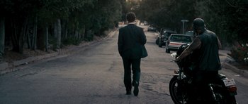 Movie still from “The Lincoln Lawyer” (2011), directed by Brad Furman – A man in a suit walking down a street; Wide shot, Over the shoulder angle