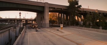 Movie still from “The Lincoln Lawyer” (2011), directed by Brad Furman – Cars and motorcycles on a street under an overpass; Extreme Wide shot, High angle