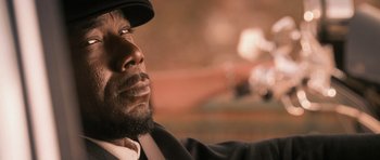 Movie still from “The Lincoln Lawyer” (2011), directed by Brad Furman – A person wearing a suit and a hat; Close Up shot, High angle