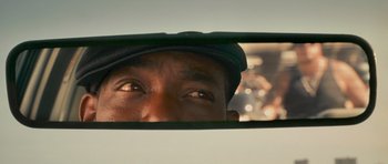 A person's eyes in a car mirror