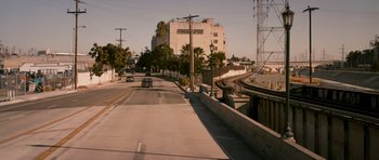 Movie still from “The Lincoln Lawyer” (2011), directed by Brad Furman – A street with a car driving down the road; Extreme Wide shot, High angle