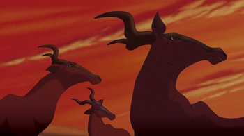Movie still from “The Lion King” (1994), directed by Rob Minkoff – A group of animals with horns; Wide shot, Low angle