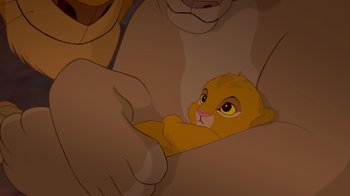 Movie still from “The Lion King” (1994), directed by Rob Minkoff – A lion cub laying in the arms of a man; Close Up shot, High angle