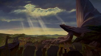 Movie still from “The Lion King” (1994), directed by Rob Minkoff – A group of people standing in front of a rock formation; Extreme Wide shot, Low angle