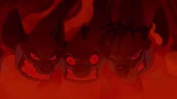 Movie still from “The Lion King” (1994), directed by Rob Minkoff – A group of three red faced animals in a dark room; Close Up shot, High angle