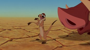 Movie still from “The Lion King” (1994), directed by Rob Minkoff – An animated animal is standing in the middle of the desert; Wide shot, Low angle