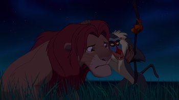 Movie still from “The Lion King” (1994), directed by Rob Minkoff – A couple of animals that are in the grass; Medium shot, Over the shoulder angle