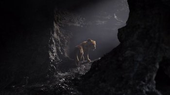 Movie still from “The Lion King” (2019), directed by Jon Favreau – A lioness walking through a cave in the dark; Wide shot, Low angle