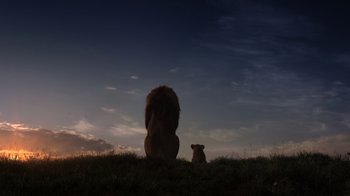 Movie still from “The Lion King” (2019), directed by Jon Favreau – A lion and a cub sitting in the grass at dusk; Extreme Wide shot, Low angle