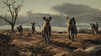 Movie still from “The Lion King” (2019), directed by Jon Favreau – A group of hyenas walking across a dry grass field; Wide shot, Low angle