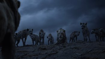 Movie still from “The Lion King” (2019), directed by Jon Favreau – A group of hyenas standing on top of a rocky hill; Wide shot, Low angle