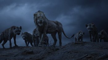 Movie still from “The Lion King” (2019), directed by Jon Favreau – A group of lions standing on top of a hill; Wide shot, Low angle