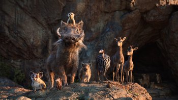 Movie still from “The Lion King” (2019), directed by Jon Favreau – A group of animals standing on top of a hill; Wide shot, Low angle