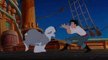 Movie still from “The Little Mermaid” (1989), directed by John Musker – A man and a dog on a boat in the ocean; Wide shot, Low angle
