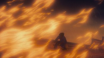 Movie still from “The Little Mermaid” (1989), directed by John Musker – A person sitting on a bench in front of a fire; Extreme Wide shot, Low angle