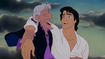 Movie still from “The Little Mermaid” (1989), directed by John Musker – An old man and a young man are in a cartoon; Close Up shot, Over the shoulder angle