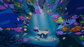Movie still from “The Little Mermaid” (1989), directed by John Musker – An underwater scene with many different colored fish; Extreme Wide shot, High angle
