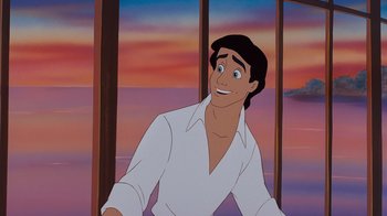 Movie still from “The Little Mermaid” (1989), directed by John Musker – A man in a white dress shirt is smiling; Medium shot, Over the shoulder angle