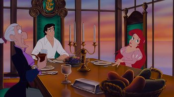 Movie still from “The Little Mermaid” (1989), directed by John Musker – A painting of people sitting at a dinner table; Medium shot, Over the shoulder angle