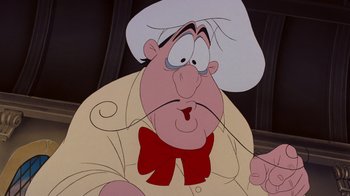 Movie still from “The Little Mermaid” (1989), directed by John Musker – A cartoon character with a bow tie; Close Up shot, Low angle