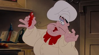 Movie still from “The Little Mermaid” (1989), directed by John Musker – A cartoon of a chef holding a red pepper; Close Up shot, Low angle