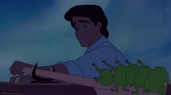 Movie still from “The Little Mermaid” (1989), directed by John Musker – A man is holding a steering wheel with frogs on it; Medium shot, Low angle