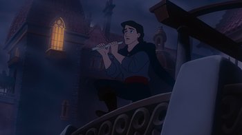 Movie still from “The Little Mermaid” (1989), directed by John Musker – A man is playing a flute in the dark; Medium shot, Low angle