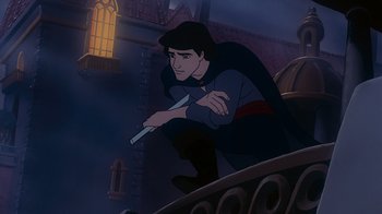 Movie still from “The Little Mermaid” (1989), directed by John Musker – A man holding a sword in front of a building; Medium shot, Low angle