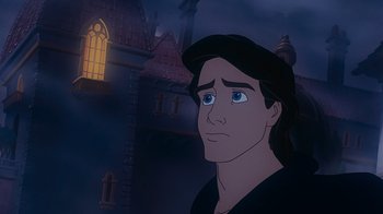 Movie still from “The Little Mermaid” (1989), directed by John Musker – A man with long black hair and blue eyes stares at the camera; Close Up shot, Low angle