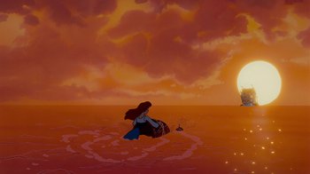 Movie still from “The Little Mermaid” (1989), directed by John Musker – A woman in the water in front of an orange sunset; Extreme Wide shot, High angle