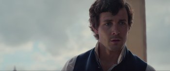 Movie still from “The Little Mermaid” (2023), directed by Rob Marshall – A person wearing a vest looking at the camera; Close Up shot, Over the shoulder angle