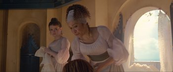 Movie still from “The Little Mermaid” (2023), directed by Rob Marshall – A woman in a white dress is looking in the mirror; Medium shot, Over the shoulder angle