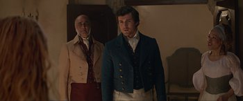 Movie still from “The Little Mermaid” (2023), directed by Rob Marshall – A man in a blue jacket standing next to another man in a white shirt; Medium shot, Over the shoulder angle