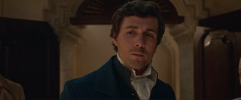 Movie still from “The Little Mermaid” (2023), directed by Rob Marshall – A person wearing a suit and tie; Close Up shot, Over the shoulder angle