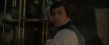 Movie still from “The Little Mermaid” (2023), directed by Rob Marshall – A man in a white shirt and a blue and white vase; Close Up shot, High angle