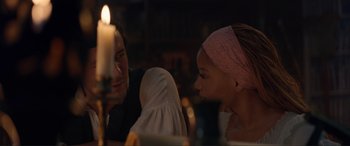 Movie still from “The Little Mermaid” (2023), directed by Rob Marshall – A man and a woman sitting in front of a lit candle; Close Up shot, Over the shoulder angle