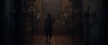 Movie still from “The Little Mermaid” (2023), directed by Rob Marshall – A man walking down the stairs of a building; Wide shot, Over the shoulder angle