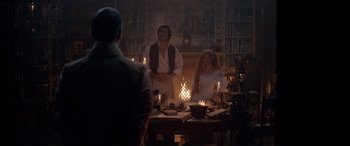 Movie still from “The Little Mermaid” (2023), directed by Rob Marshall – A man and a woman sitting at a table with candles; Wide shot, Over the shoulder angle