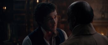 Movie still from “The Little Mermaid” (2023), directed by Rob Marshall – A man in a vest and a man with a beard; Close Up shot, Over the shoulder angle